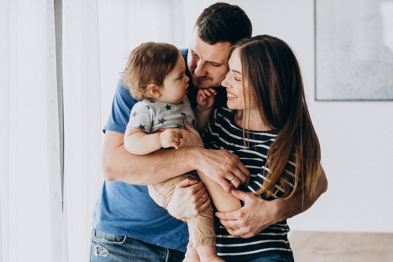Young family with their little son at home